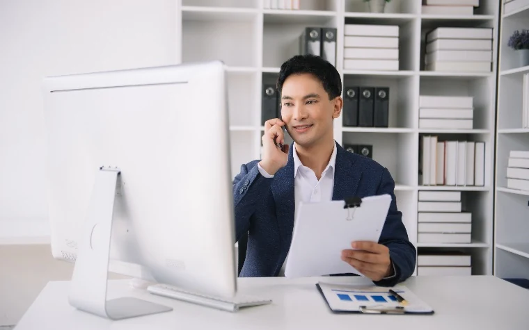 Sales rep wearing a headset practicing a conversation at a laptop