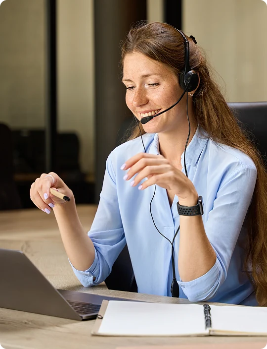 Automotive salesperson smiling on a call at a laptop