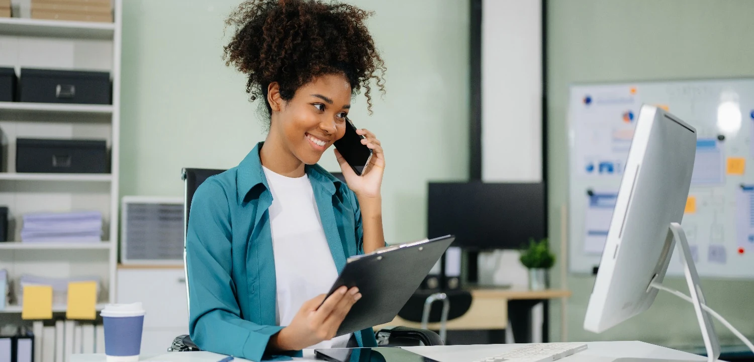 Financial advisor reviewing notes during a client call