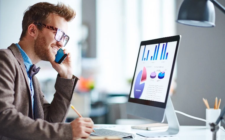 Sales rep handling a call with confidence at his desk
