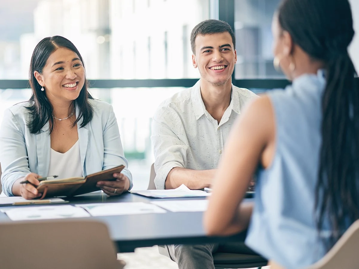 FunnelX team members talking together in a bright meeting room